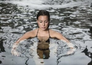 Une femme qui réalise des exercices dans une piscine.